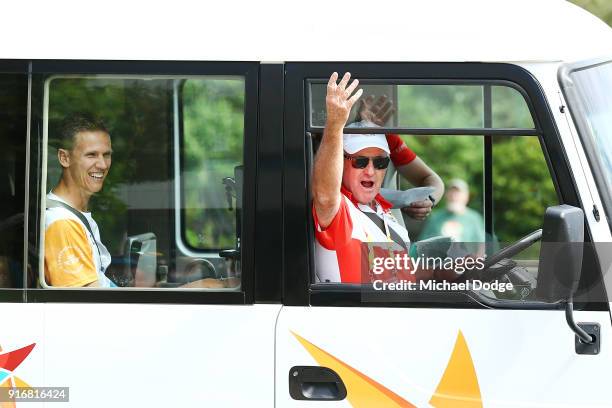 The bus driver tries to motivate the crowd while driving Queens Baton carrier Dan Langelaan to his position during the Queens Baton Commonwealth...