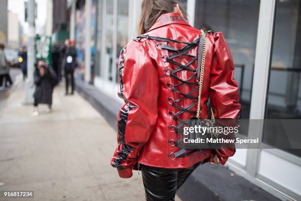 Guest is seen on the street attending Taoray Wang during New York Fashion Week wearing a vinyl red jacket on February 10, 2018 in New York City.