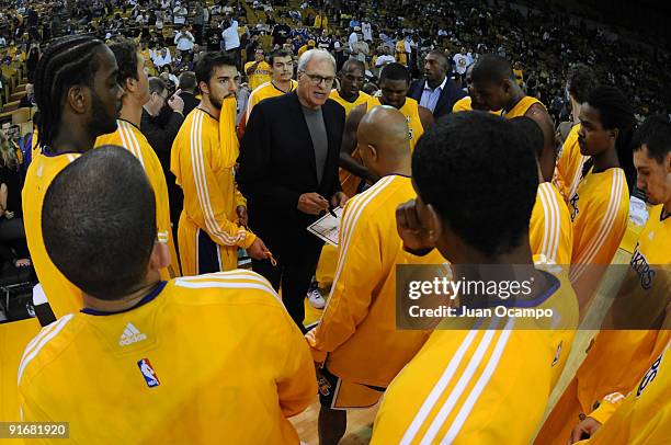 Head Coach Phil Jackson of the Los Angeles Lakers instructs his team during a pre-season game against the Golden State Warriors at The Forum on...