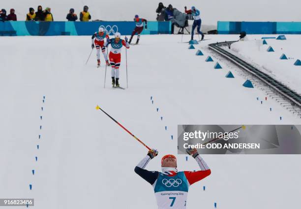 Norway's Simen Hegstad Krueger crosses the line to win gold followed by Norway's Martin Johnsrud Sundby and Norway's Hans Christer Holund at the end...