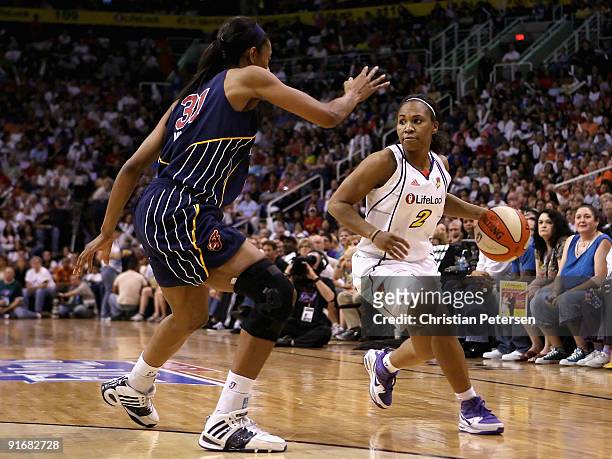 Temeka Johnson of the Phoenix Mercury handles the ball under pressure from Jessica Moore of the Indiana Fever in Game Five of the 2009 WNBA Finals at...