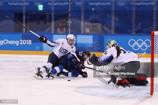 Kacey Bellamy of the United States falls on Michelle Karvinen of Finland in the second period during the Women's Ice Hockey Preliminary Round - Group...