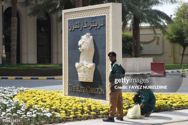 Picture taken on February 11, 2018 shows foreign labourers working outside the main entrance of the Ritz Carlton hotel in the Saudi capital Riyadh...