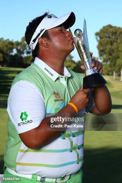 Kiradech Aphibarnrat of Thailand kisses the trophy after winning the final match against James Nitties of Australia during day four of the World...