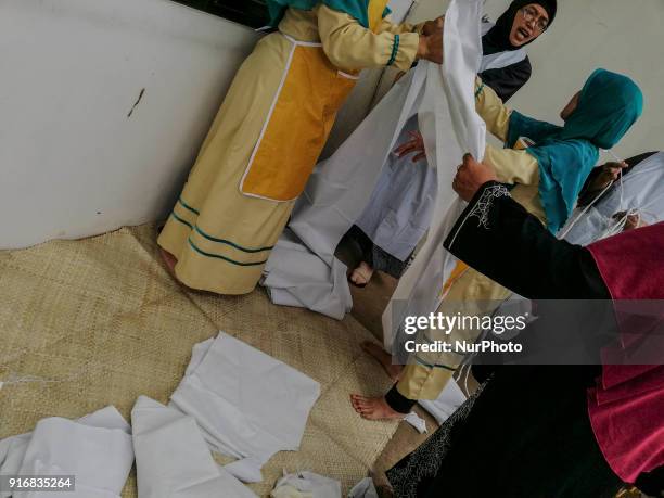 Women prepared for &quot;kaffan&quot; shirt for the dead victim as South Tangerang Hospital before mass grave in Ciputat, Tangerang, Banten,...