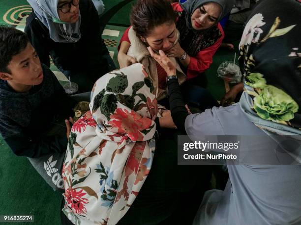Family of the victim cried before the mass grave in Ciputat, Tangerang, Banten, Indonesia 11 February 2018. Victims dead from deadly bus accident at...