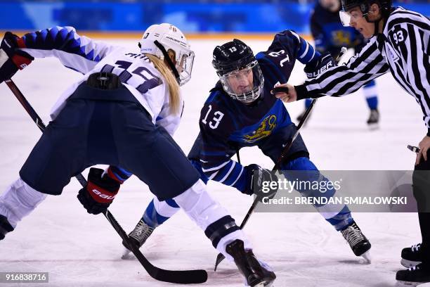 S Gigi Marvin and Finland's Riikka Valila wait to face off during the final period of the women's preliminary round ice hockey match between Finland...