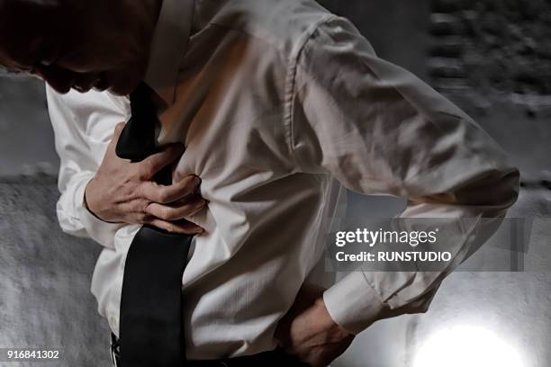 middle aged man suffering from chest pain - chest pain stock pictures, royalty-free photos & images