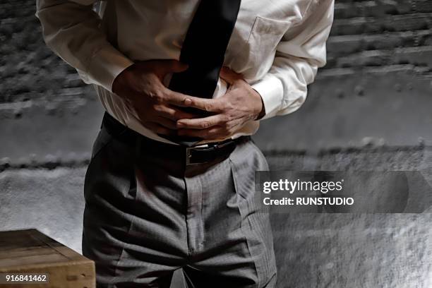 middle aged man with stomachache - indigestion stock pictures, royalty-free photos & images