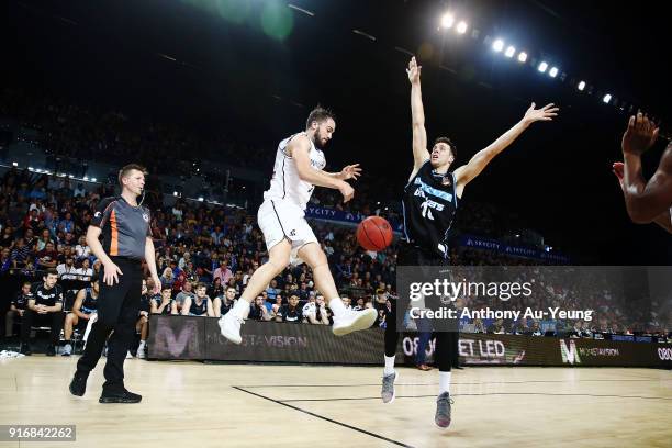 Peter Hooley of United throws the ball on Tom Abercrombie of the Breakers to force a side ball during the round 18 NBL match between the New Zealand...