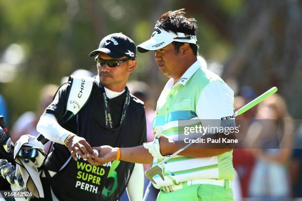 Kiradech Aphibarnrat of Thailand looks on with his caddie in the final match against James Nitties of Australia during day four of the World Super 6...