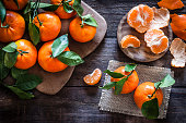 Fresh organic mandarins on rustic wooden table