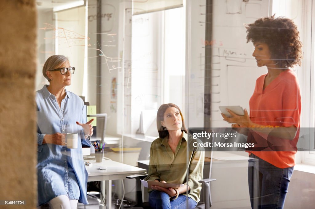 Businesswomen discussing plan in new office