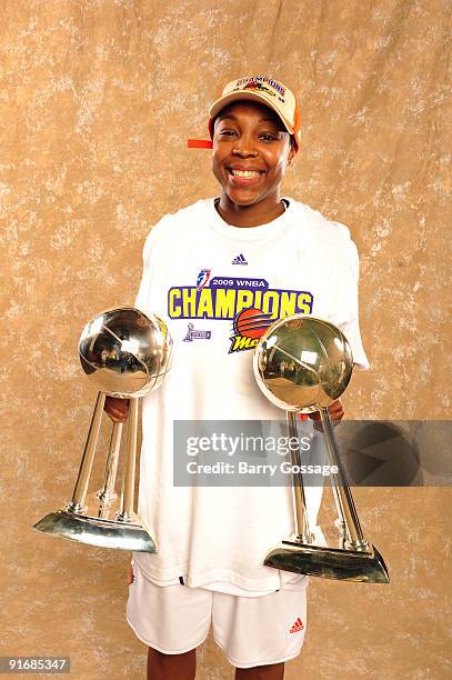 Cappie Pondexter of the Phoenix Mercury poses with the 2007 and 2009 WNBA Championship Trophies after the Mercury defeated the Indiana Fever 94-86 in...