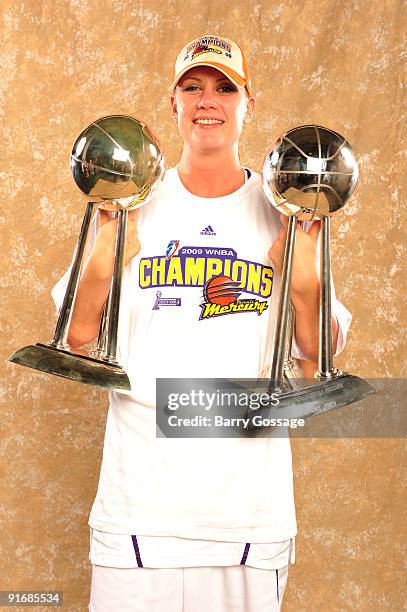 Penny Taylor of the Phoenix Mercury poses with the 2007 and 2009 WNBA Championship Trophies after the Mercury defeated the Indiana Fever 94-86 in...