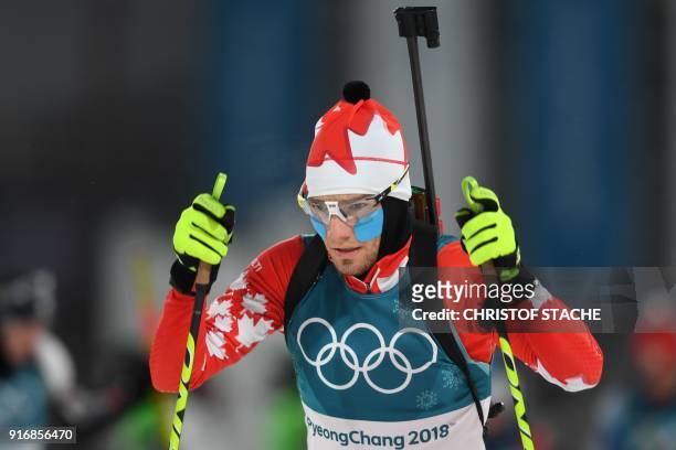 Canada's Christian Gow wears cheek warmers prior to the start of the men's 10km sprint biathlon event during the Pyeongchang 2018 Winter Olympic...
