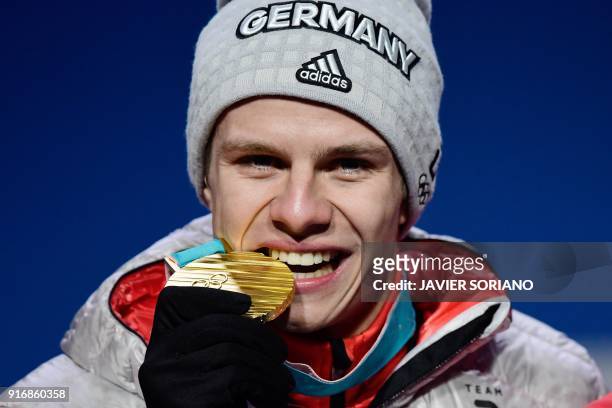 Germany's gold medallist Andreas Wellinger poses on the podium during the medal ceremony for the ski jumping Men's Normal Hill Individual at the...