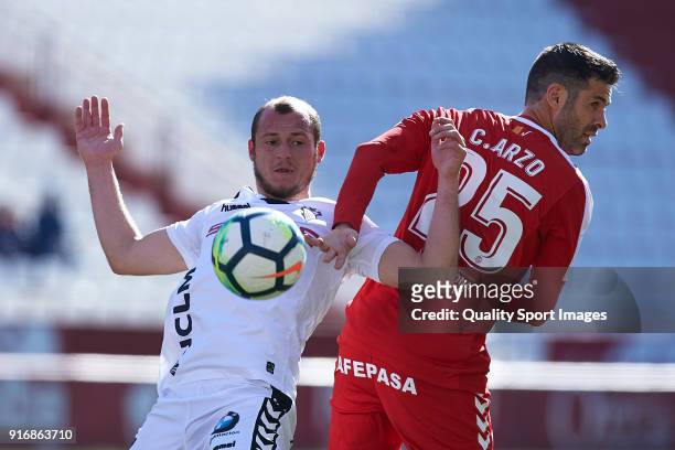 Roman Zozulia of Albacete competes for the ball with Cesar Arzo of Nastic during the La Liga 123 match between Albacete Balompie and Nastic at...