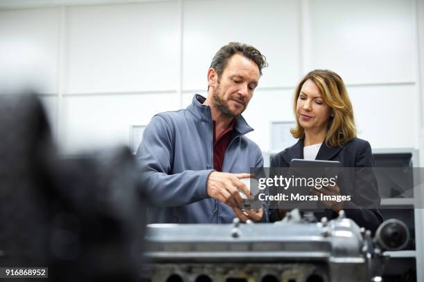 manager and engineer with tablet pc and piston - piston stock pictures, royalty-free photos & images