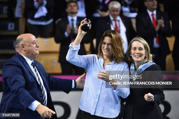 Former tennis player and former France's Fed Cup tennis coach, Amelie Mauresmo reacts after she received from French Tennis Federation President,...