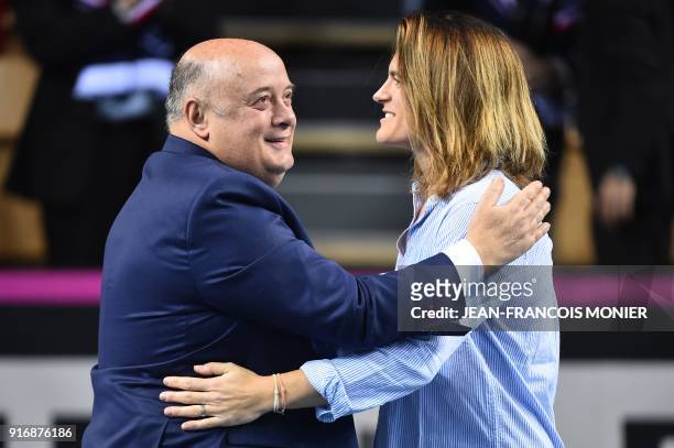Former tennis player and former France's Fed Cup tennis coach, Amelie Mauresmo hugs French Tennis Federation President, Bernard Giudicelli after she...