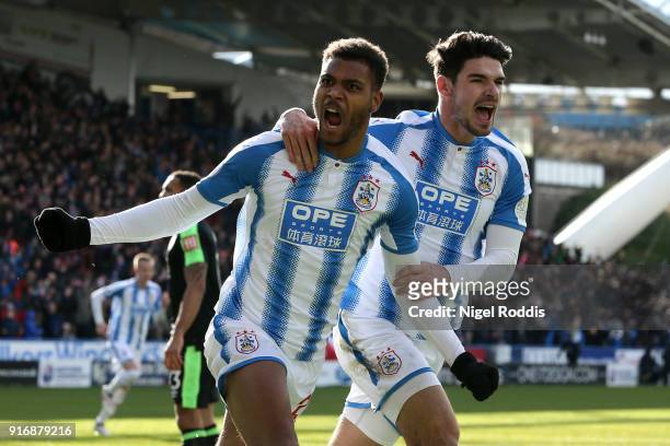 Steve Mounie of Huddersfield Town celebrates with teammate Christopher Schindler after scoring his sides second goal during the Premier League match...