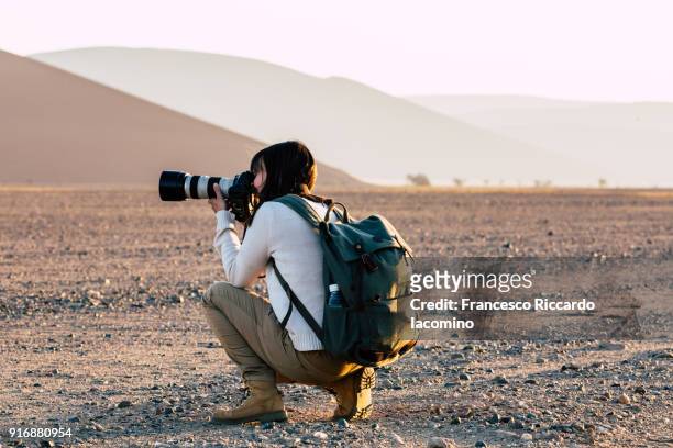 photographer at namib desert - photographer stock-fotos und bilder