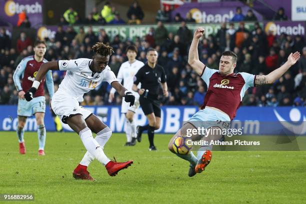 Tammy Abraham of Swansea City is challenged by Kevin Long of Burnley during the Premier League match between Swansea City and Burnley at the Liberty...
