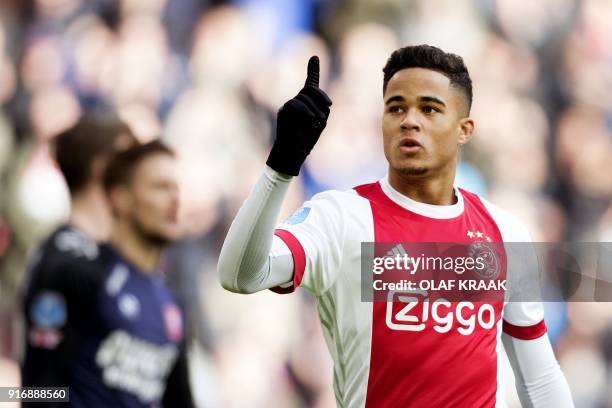 Ajax Amsterdam's midfielder Justin Kluivert reacts after opening the scoring during the Dutch Eredivisie soccer match between Ajax Amsterdam and FC...