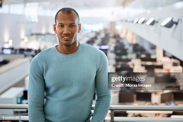 confident young businessman standing at railing - receding hairline stock pictures, royalty-free photos & images