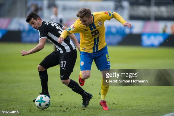 Christoffer Nyman of Braunschweig is challenged by Julian-Maurice Derstroff of Sandhausen during the Second Bundesliga match between SV Sandhausen...