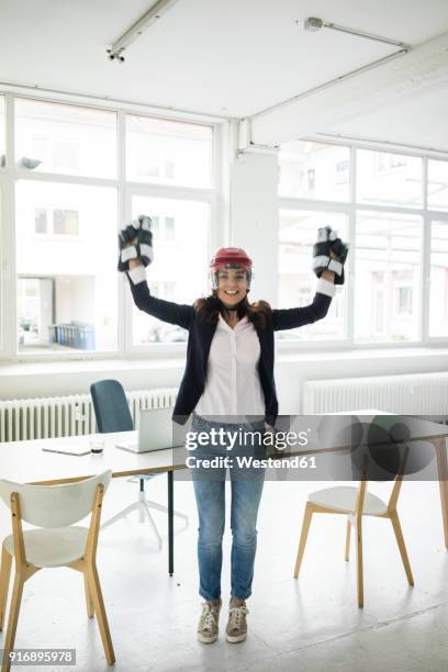portrait of businesswoman wearing ice hockey equipment - ice hockey glove stock-fotos und bilder