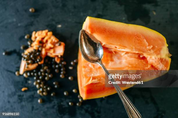 papaya cut with spoon on slate plate - papaya stock pictures, royalty-free photos & images