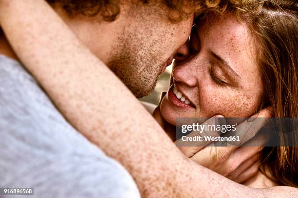 happy young couple hugging - kiss fotografías e imágenes de stock