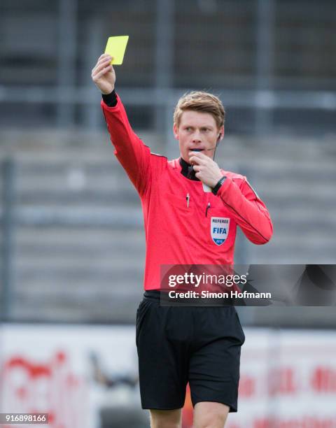 Referee Christian Dingert shows the yellow card during the Second Bundesliga match between SV Sandhausen and Eintracht Braunschweig at BWT-Stadion am...