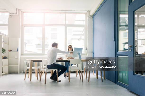 man and woman discussing in office - small business copy space stock pictures, royalty-free photos & images