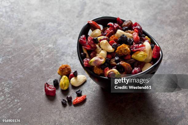 bowl of dried fruits, pistachios, cashew nuts and almonds - gedroogd fruit stockfoto's en -beelden