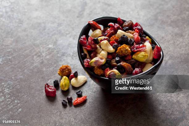 bowl of dried fruits, pistachios, cashew nuts and almonds - torkad frukt bildbanksfoton och bilder
