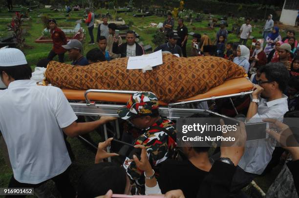 Residents carrying the bodies of victims of the bus accident arrived the funeral in Ciputat, Indonesia, Sunday, February 11, 2018. A total of 26...