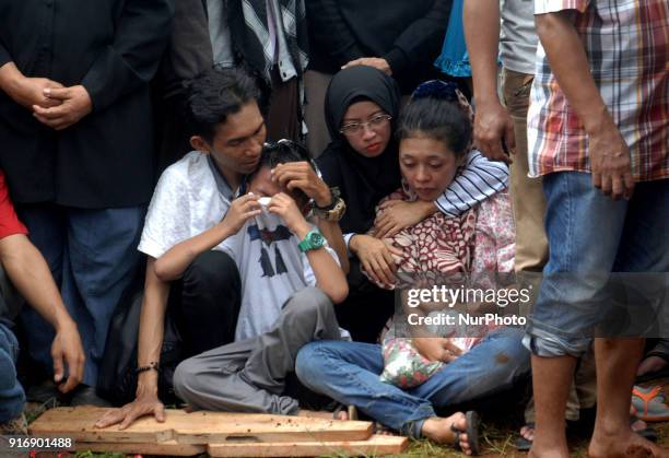 The family cried during the victim's journey at the grave in a bus accident at a funeral in Ciputat, Indonesia, Sunday, 11 February 2018. A total of...