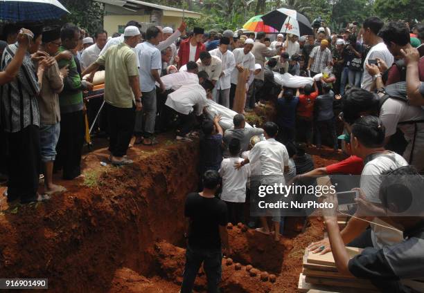 Residents carrying the bodies of victims of the bus accident arrived the funeral in Ciputat, Indonesia, Sunday, February 11, 2018. A total of 26...