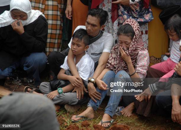The family cried during the victim's journey at the grave in a bus accident at a funeral in Ciputat, Indonesia, Sunday, 11 February 2018. A total of...
