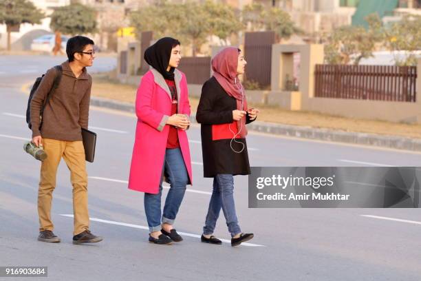 young girls in hijab (head scarf) and a boy walking and enjoying on the road - punjabi girls images 個照片及圖片檔