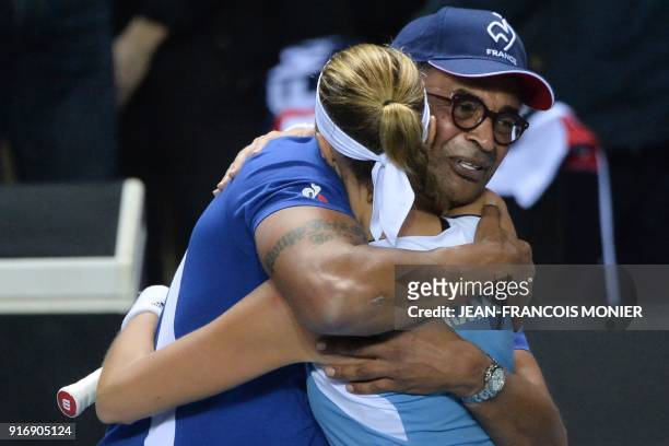France's captain Yannick Noah congratulates France's Kristina Mladenovic after she defeated Belgium's Elise Mertens during the Tennis Fed Cup world...
