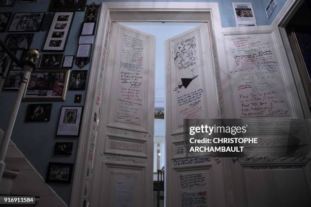 Messages written by friends of the late French writer Gonzague Saint-Bris adorn a set of doors in his flat in Paris on January 22, 2018. / AFP PHOTO...