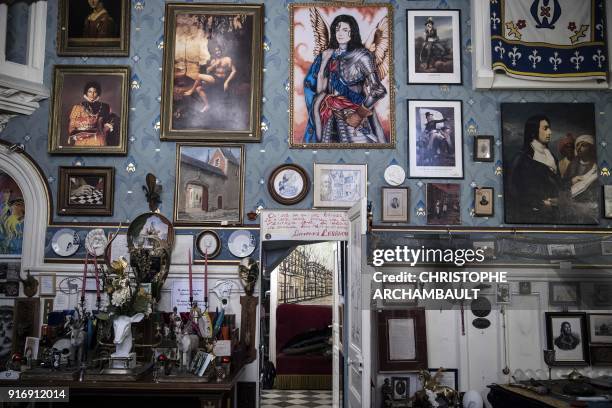 Frames, plates, statues and various objects adorn the walls of the late French writer Gonzague Saint-Bris' flat in Paris on January 22, 2018. / AFP...