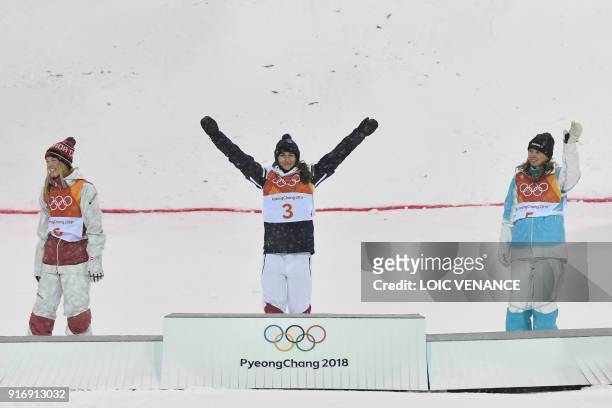Canada's Justine Dufour-Lapointe, France's Perrine Laffont and Kazakhstan's Yulia Galysheva celebrate on the podium during the victory ceremony after...
