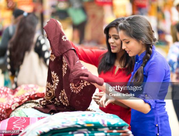 women shopping for dress at street market - india market stock pictures, royalty-free photos & images