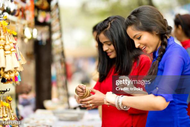 women shopping for bangles at street market stall - bangle stock pictures, royalty-free photos & images