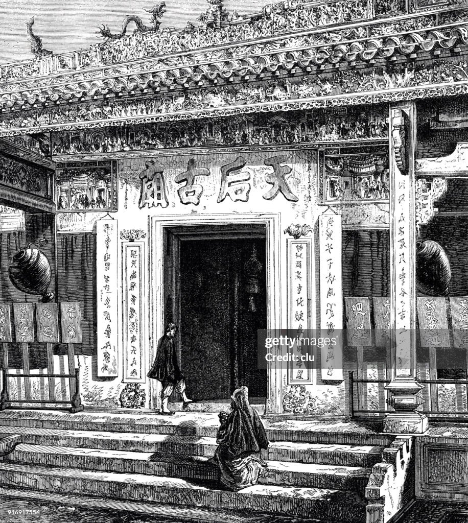People walk in a temple in Hong Kong